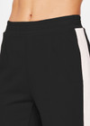 THE UPSIDE women's black Petra Flare is made from a lenzing viscose soft suiting fabrication. The full length tailored pant features side pockets and an elasticated waistband. Designed for walking and recovery.