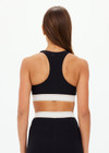 THE UPSIDE women's black Jagger Ness Racerback Bra is made from recycled sof peach with a brushed handfeel and moisture wicking, breathable and quick drying properties. This supportive, t back sports bra feature removable bust cups and discreet mesh pocket at the back. Designed for yoga, pilates and barre.