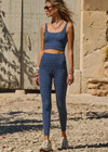 THE UPSIDE women's blue abstract print Farrow 25 inch High Midi Pant is made from a recycled jacquard rib fabric with breathable, quick drying and moisture wicking properties. This high waisted legging features a V-shaped front and is designed for yoga, pilates and barre.