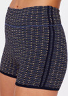 THE UPSIDE women's navy Caleta 3 inch Spin Short is made with gold lurex, a speciality fabric. The mid rise spin short is framed in navy ribbed binds with a speciality curved leg line. Designed for yoga, pilates and walking.