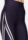 THE UPSIDE women's navy Cordoba 25 inch Midi Pant is made from a eco tech performance fabric making the pant breathable and quick drying. The mid rise pant features a printed white stripe down the leg creating a sporty chic look. Designed for the gym and running.