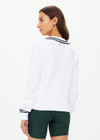 THE UPSIDE women's white Sonny V Neck Knit Sweater is made from organic cotton. The classic V neck knit features a navy and green stripe at the neck and sleeve for an elevated finish. Designed for leisure and recovery.