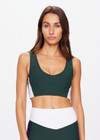 THE UPSIDE women's green Playoff Issac V Neck Bra is made from a recycled soft peached fabrication with a brushed handfeel creating a breathable and quick drying effect. The sports bra features a V neckline and removable bust cups for comfort and style. Designed for golf.