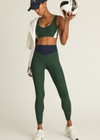 THE UPSIDE women's green Playoff 25 inch High Midi Pant is made from a recycled soft peached fabrication with a brushed handfeel, creating the pant to be breathable and quick drying. The green pant is paired with navy and white for an elevated look. Designed for golf.