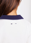 THE UPSIDE women's white Jacobs V Neck Collared Polo is made from organic cotton. The slim fit white polo is contrasted with navy and a rounded collar. Designed for golf.