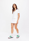 THE UPSIDE women's white Jacobs V Neck Collared Polo is made from organic cotton. The slim fit white polo is contrasted with navy and a rounded collar. Designed for golf.