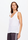 THE UPSIDE women's white Muse Wales Knit Tank Top is made from a organic cotton knit construction.The basketball tank shape features a ribbed neckline and armholes. Designed for light movement and recovery.