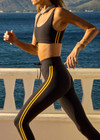 THE UPSIDE women's black Beaufort Harley Scoop Bra is made from recycled soft peached fabrication with a brushed handfeel for a breathable and quick drying effect. The sports bra has a scoop front and back neckline and elasticated underbust with removable cups for comfort and yellow stripes down the side for style. Designed for the gym and running.