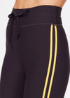 THE UPSIDE women's black Beaufort 25 inch Midi Pant is made from recycled soft peached fabrication with a brushed handfeel for a breathable and quick drying effect. The mid rise pant features an elasticated drawcord for the perfect fit and yellow stripes down the side for style. Designed for the gym and running.