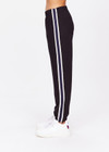 THE UPSIDE women's black Beaufort Cala Zip Pant is made from soft lenzing fabric. The slim fit track pant features contrast white and navy stripe down the sides, elasticated waist and cuffs, invisible zips at cuffs and front and back pockets.