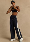 THE UPSIDE women's navy Hamptons Saylor Wide Leg Pant is made from a soft suiting lenzing fabrication. The wide leg pant is fitted with cargo pockets and an elasticated waistband with drawcord. Designed for leisure and recovery.