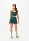 THE UPSIDE women's green Peached Lucette Pleated Dress is made in a recycled soft peached fabric with a brushed handfeel for a breathable and quick drying effect. The panelled mini dress is fitted with a pleated skirt and straight back straps with a scooped neckline for style and built in shorts and internal shelf bra for practicality and comfort. Designed for Tennis.