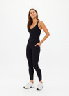 THE UPSIDE women's black recycled peached Laurie Tank Top provides mid coverage longline tank top with a scooped T bar back and internal underbust elastic and removable cups. The fabric is breathable and moisture wicking.