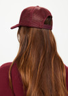 THE UPSIDE women's maroon Cheval Classic Trucker Hat features a foam front and mesh back with an adjustable snapper.