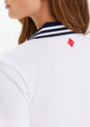 THE UPSIDE women's white Renshaw Luma Zip Collared Polo is made from organic cotton. The boxy fit pique polo features navy ribbed collar. Designed for tennis and pickleball.
