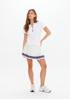 THE UPSIDE women's white Renshaw Luma Zip Collared Polo is made from organic cotton. The boxy fit pique polo features navy ribbed collar. Designed for tennis and pickleball.