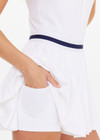 THE UPSIDE women's white Renshaw Beth Pleated Dress is made from recycled peached. The tennis dress features built in shorts with pockets. Designed for tennis and pickleball.