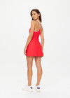 THE UPSIDE women's red Pacific Ali Racer Back Dress is made from recycled peached. The scoop neck tennis dress features built in shorts with pockets. Designed for tennis and pickleball.