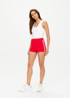 THE UPSIDE women's red Montana Bisou Knit Short is made from recycled fabric. The mid-rise shorts features knitted side stripes. Designed for lifestyle wear.