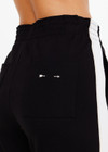 THE UPSIDE women's black Monte Pant is made from a lenzing viscose soft suiting fabrication. This high waisted wide leg pant features an elastic waistband, stripe tape down the side seams, and side seam and back patch pockets. Designed for leisure and recovery.
