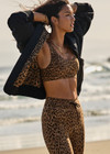 THE UPSIDE women's leopard Panthera Daisy Scoop Neck Bra is made from recycled peached. The supportive sports bra features removable cups. Designed for yoga.