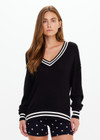 THE UPSIDE women's black Duet V Neck Cable Knit Sweater is made from organic cotton. The relaxed long sleeve sweater is Designed for comfort.
