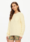 THE UPSIDE women's butter yellow Boo Cable Knit Sweater is made with organic cotton and features a patch pocket at chest and ribbed cuff, neck, and hem.