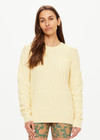 THE UPSIDE women's butter yellow Boo Cable Knit Sweater is made with organic cotton and features a patch pocket at chest and ribbed cuff, neck, and hem.