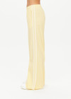THE UPSIDE women's butter yellow Juliet Low Waist Trackpant is made from a slinky, lightweight fabric and feature side stripes, pockets and a split flared hem.