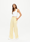 THE UPSIDE women's butter yellow Juliet Low Waist Trackpant is made from a slinky, lightweight fabric and feature side stripes, pockets and a split flared hem.