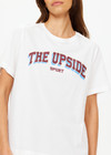 THE UPSIDE women's white Alumni Jodhi Tee is made with organic cotton jersey and is designed with a classic crew neck shape with a logo across the chest.