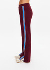 THE UPSIDE women's maroon Ryder Petra Flare Trackpant feature blue side stripes, a split hem, elasticated waist and side pockets.