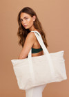 THE UPSIDE women's cream Marbella Beach Club Tote is made from cotton linen blend. The large tote bag features outer pockets and removable matching purse.