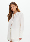 THE UPSIDE women's cream Hotel Du Cap Long Sleeve Shirt is made from tencel linen blend. The button up shirt features wide sleeve cuffs. Designed for layering and travel.