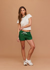THE UPSIDE women's green Tennis in Bahamas Run Short is a mid rise short with a drawstring. Designed for running and exercise.