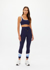 THE UPSIDE women's navy Silverstone Harley Scoop Sports Bra is designed for a supportive fit featuring a recycled rib fabrication and removable bust cups. Ideal for yoga and pilates.