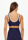 THE UPSIDE women's navy Silverstone Harley Scoop Sports Bra is designed for a supportive fit featuring a recycled rib fabrication and removable bust cups. Ideal for yoga and pilates.