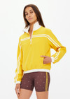 THE UPSIDE women's recycled fabric Prix Dawson Run Jacket in mimosa yellow is light and breathable whilst being water resistant and moisture wicking. Large back pocket with zip makes stow away and packing easy.