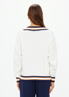 THE UPSIDE women's white organic cotton Josette V Neck Knit Sweater features a striped cable neckline in orange and navy. Made for everyday leisure.