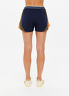 THE UPSIDE women's navy recycled fabric Starburst Lucky Run Short is designed for a true to size fit with invisible side zip pockets. Made for running.
