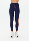 THE UPSIDE women's navy Oxford 25in Legging is designed for high impact with a breathable, moisture wicking recycled fabrication. Featuring a striped elasticated draw cord waist.