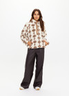 THE UPSIDE women's beige recycled fleece fabrication Harlow Fleece Pullover is a relaxed pullover style with quarter zip through and zip pockets.
