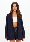 THE UPSIDE women's navy pinstripe merino Wool Boyfriend Blazer is a fully lined single breasted blazer with branded tortoiseshell buttons. Lean into a polished kind of comfort with our Wool Boyfriend Blazer.