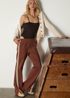 THE UPSIDE women's chocolate brown Petra Flare Pant is made from a sustainable lenzing viscose material that features a contrast white knitted tape down the sides. This track pant features an elasticated waist and side pockets.