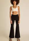 THE UPSIDE women's black classic Joyela Flare Pant is made from a lenzing viscose blend and features an embroidered arrow at the black.