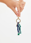 THE UPSIDE navy Arrow Keyring features a gold metal star and macrame paracord in classic navy and white, finished with rubber-dipped ends.