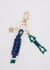 THE UPSIDE navy Arrow Keyring features a gold metal star and macrame paracord in classic navy and white, finished with rubber-dipped ends.
