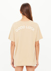 THE UPSIDE women's natural organic cotton Good Luck Sammi Tee is designed for an oversized fit and features "Good Luck" in cream printed on back. Made for versatile styling.
