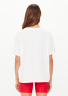 THE UPSIDE women's organic cotton creme Feeling Lucky Jodhi Tee features a classic shape and Feeling Lucky graphic printed on the front chest. Made for everyday wear.