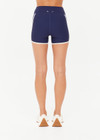 THE UPSIDE women’s navy recycled peached Samara 3.5inch Spin Short offers a soft & supportive fit and features side pockets and contrast cream stripes . Made for pilates.